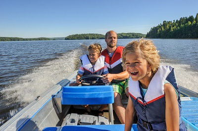family enjoying their boat on a lake in Illinois